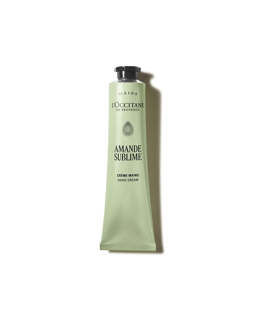 a tube of hand cream with a green color and a black cap.