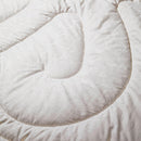a close-up view of a white, fluffy, and soft-looking fabric, possibly a blanket or a comforter.