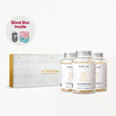 a set of three bottles of Teddi Lab's "The Luminous Ritual" supplement, along with a box containing the same product. The text "Blind Box Inside" is visible, suggesting that the viewer should open the box to see the contents inside.