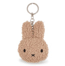 A keychain in the shape of a bunny with a fuzzy texture and a black eye and nose.