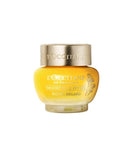 A jar of lotion with a gold cap and a yellow label.