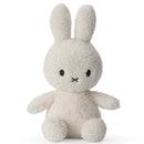 A white stuffed bunny toy with black eyes and a black x on its face.
