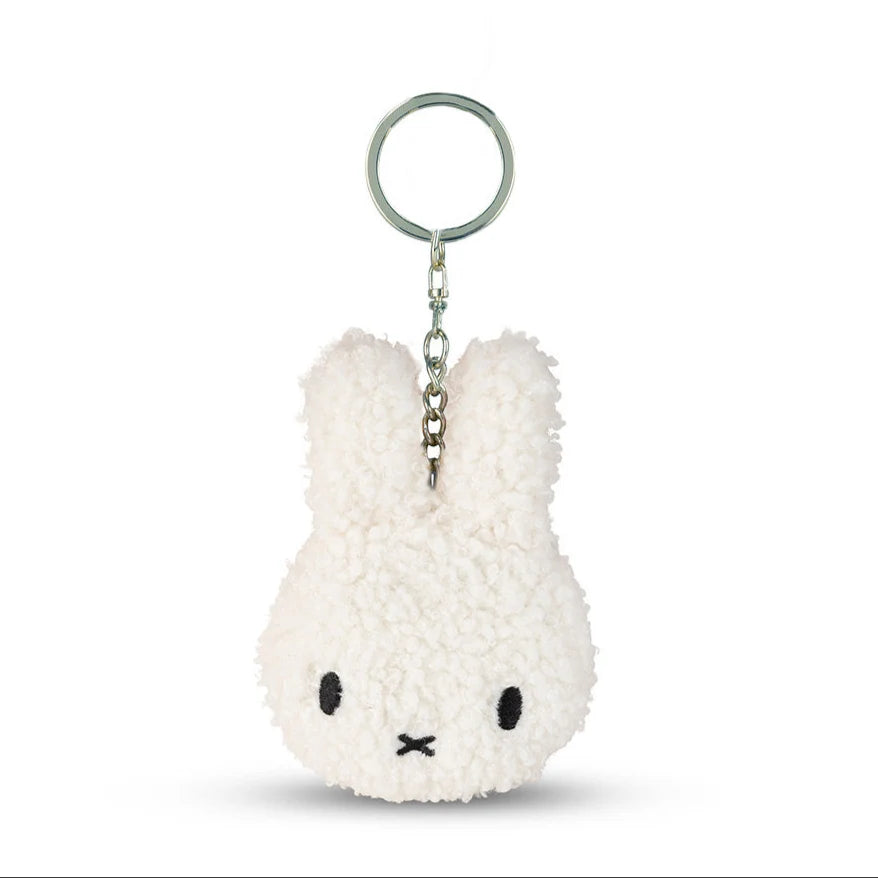 A white plush rabbit keychain with a black eye and nose design.
