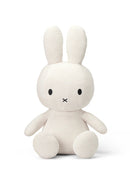 A white stuffed rabbit toy with black eyes and a black x on its face.