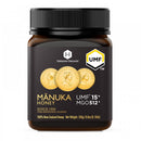 a bottle of Manuka Honey with a black cap and a label that includes text and images.
