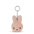 A pink, fluffy keychain in the shape of a bunny with a black nose and eyes.