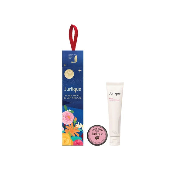 a blue box with a red ribbon, a white tube, and a pink circular object, all of which appear to be related to beauty or skincare products.