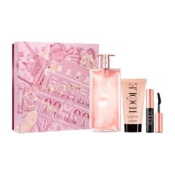 A collection of beauty products, including a perfume bottle, a tube of lipstick, and a tube of mascara, all displayed against a pink background.