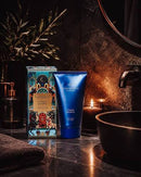a bathroom counter with a blue tube of "Citadel Secrets" lotion, a candle, and a decorative box.