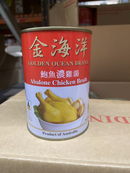 A can of Golden Ocean Brand Abalone Chicken Broth is sitting on a cardboard box.