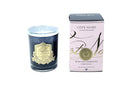 a dark glass candle with a gold label and a pink box with gold lettering, both of which are part of the Côte Noire Collection.