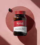 A bottle of Astaxanthin A1 supplement against a pink background.