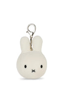 A white plush rabbit charm with black eyes and mouth, attached to a silver metal clasp.