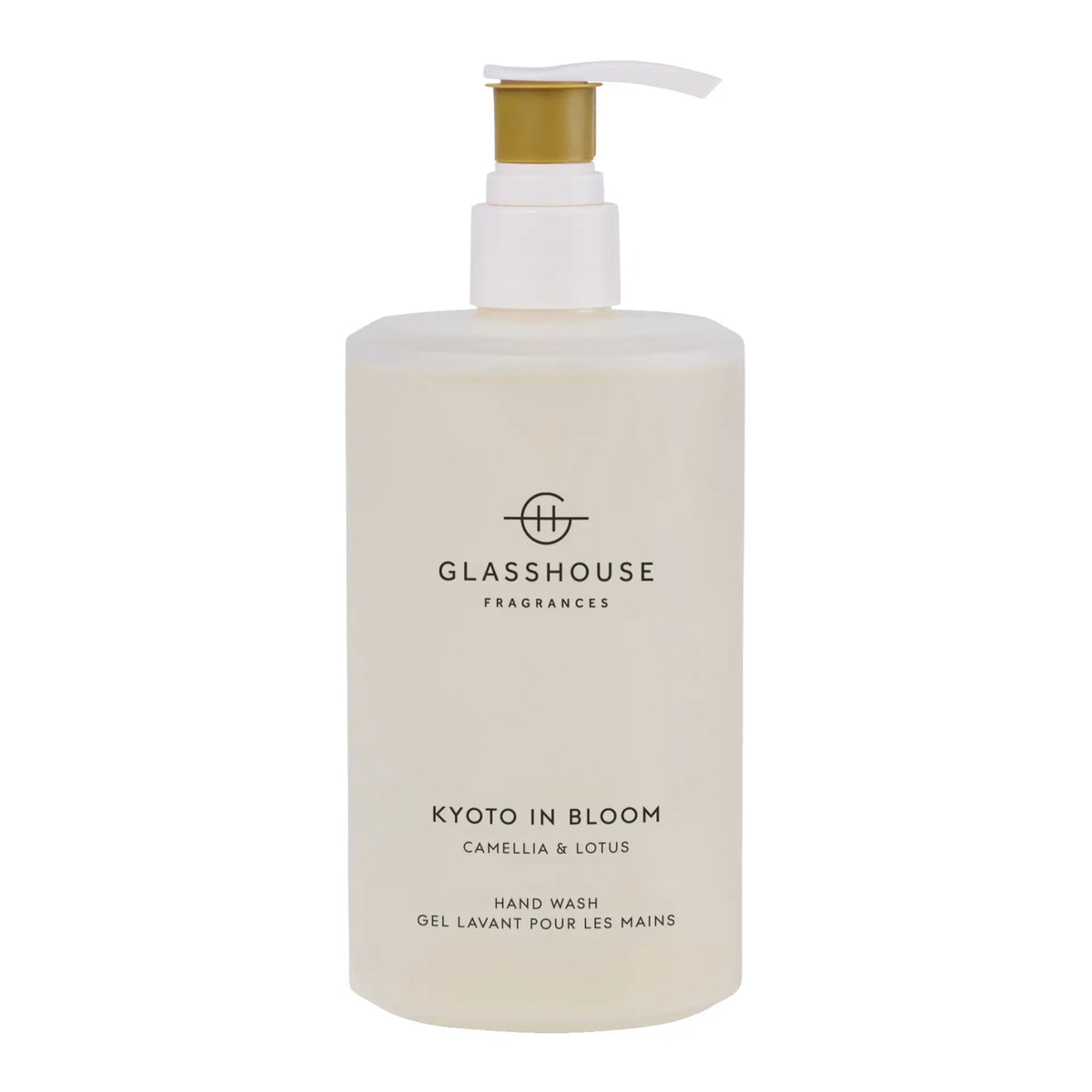 A bottle of hand wash with a pump dispenser, labeled as "KOTO IN BLOOM CAMELLIA & LOSUS".