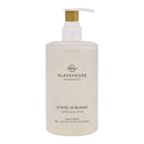 A bottle of hand wash with a pump dispenser, labeled as "KOTO IN BLOOM CAMELLIA & LOSUS".