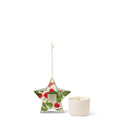 A white candle and a star-shaped paper ornament with a floral design are displayed against a white background.