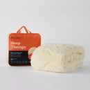 An orange and black package labeled "MINJUMBUK Sleep Therapy" next to a fluffy white blanket, both placed on a white background.