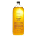 A large bottle of liquid hand soap with a yellowish liquid inside.
