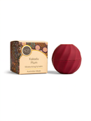 a box of Kakadu Plum lip balm next to a red lip balm container.