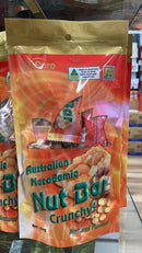 A bag of Australian Macadamia Nut Bar crunchy snacks is displayed on a shelf.
