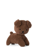 A brown stuffed animal dog toy is sitting on a white background.
