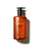 An orange bottle of L'OCCITANE le Savon Verveine soap against a black background.