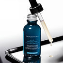 A bottle of SkinCeuticals Age-Interrupter Ultra Serum is shown with a dropper, indicating that the product is ready for use.