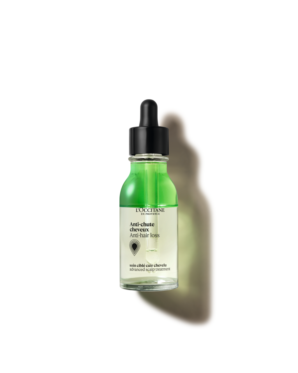 A bottle of green liquid with a black cap, labeled as an anti-churning hair loss treatment from the brand L'OCCITANE.