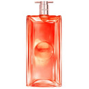 A tall, rectangular bottle with a pink cap, containing a bright orange liquid.
