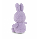 A purple plush bunny toy is sitting on a white background.
