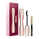 a set of makeup products from the Lancome brand, including a mascara, eyeliner, and an eyelash curler.