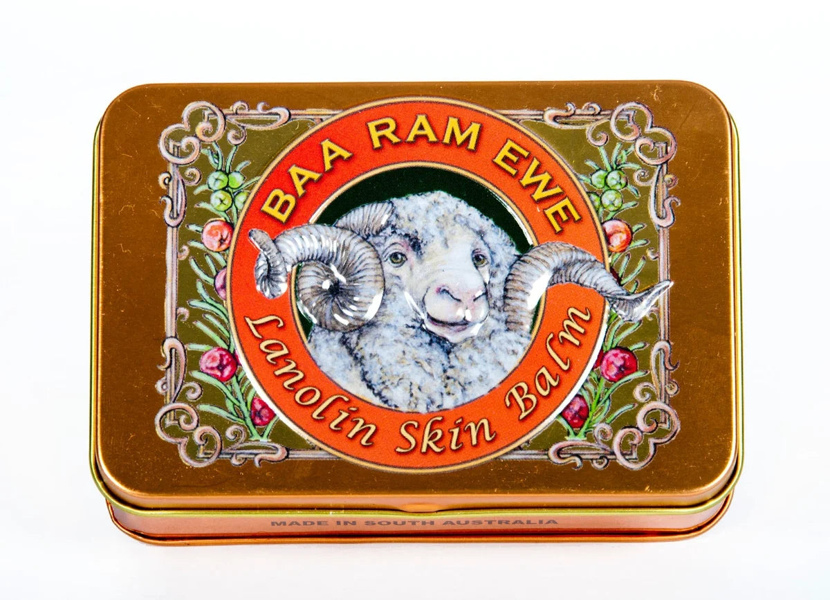 a tin can with a picture of a ram's head and the text "BAA RAM EWE Lanolin Skin Balm" around it.