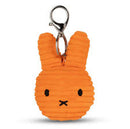 An orange, textured keychain in the shape of a rabbit's head with black eyes and a black nose.