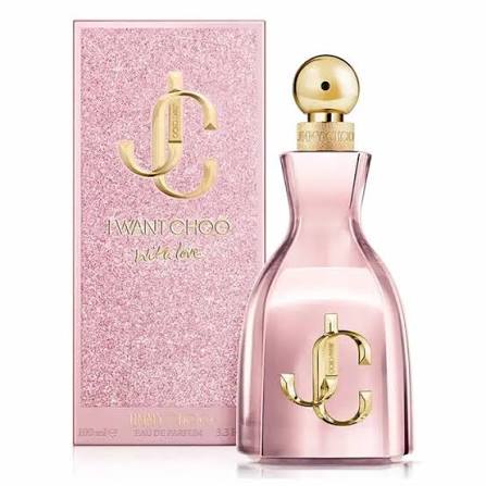 A pink perfume bottle with a gold cap and a pink box with gold glittering text and logo.