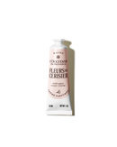 A tube of hand cream with a label that reads "MAINS L'OCCITANE DE PROVENCE FLUERS de CERISIER PERFUMED HAND CREAM" and "30 ML NET WT. 1 OZ".