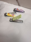 Three colorful nail clippers with cartoon animal designs are placed on a white surface.
