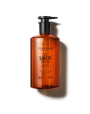 An orange bottle of liquid soap with a pump dispenser, labeled as a "L'OCCITANE L'SAVON LAVANDE" soap.
