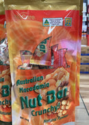 A bag of Australian Macadamia Nut Bar crunchy snacks is displayed on a shelf.