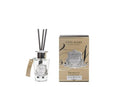 a glass diffuser with three black sticks and a box of Côte Noire Prosecco.