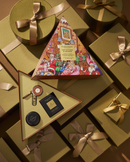 a collection of gift boxes and presents, some of which are wrapped in gold ribbons. The boxes appear to be gift-wrapped and contain various items, such as a small black box and a larger box with a colorful, illustrated design. The overall scene suggests a festive or holiday-themed setting, with the gift boxes and presents arranged in a visually appealing manner.