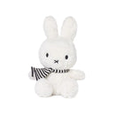 A white stuffed rabbit wearing a striped scarf.