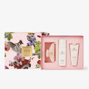 a pink box with a floral design and a pink box with a white design, both containing skincare products.