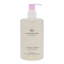 A bottle of GLASSHOUSE Fragrances hand wash with a pink pump dispenser.