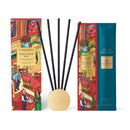 two boxes of glasshouse scent duo and velvet rhapsody, along with a set of black reeds and a small round gold object.