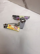 a pair of colorful nail clippers with a cartoon character design, placed on a white surface.