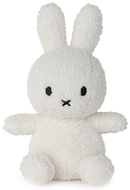 A white stuffed bunny toy with black eyes and a black mouth.