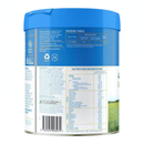 The image is a can of baby food with a blue lid, featuring nutritional information and ingredients.