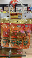 A display of Nucare Macadamia Nut Bar snacks in clear plastic bags, with a clear plastic bag handle attached to the top of the display.