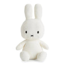 A white plush toy rabbit with black eyes and a black mouth.