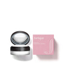 a black and white makeup compact and a pink box with the word "Jurlique" printed on it.